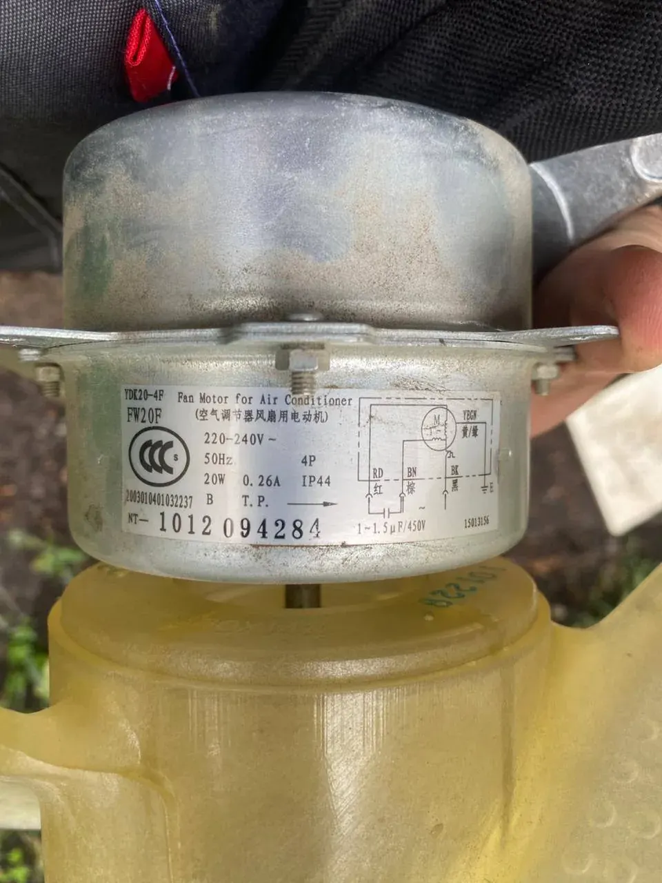 Label on an air conditioner fan motor with voltage and power specifications Label on an air conditioner fan motor with voltage and power specifications